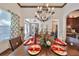 Bright dining room with hardwood floors, chandelier, and elegant place settings at 6646 Park Strand Dr, Apollo Beach, FL 33572