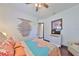 Bright bedroom with a queen bed and ceiling fan at 6646 Park Strand Dr, Apollo Beach, FL 33572