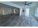 Open living room with wood-look flooring and high ceilings at 7231 Big Bend Dr, Spring Hill, FL 34606