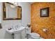 Stylish powder room with unique orange wall texture at 795 Collany Rd # 304, St Petersburg, FL 33715