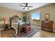 Charming bedroom with large window, hardwood floor, and antique furniture at 795 Collany Rd # 304, St Petersburg, FL 33715