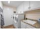 Bright laundry room with washer, dryer, and utility sink at 795 Collany Rd # 304, St Petersburg, FL 33715