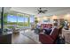 Spacious living room with water views, leather furniture, and hardwood floors at 795 Collany Rd # 304, St Petersburg, FL 33715