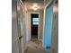 Hallway with carpet, access to bathroom, and closets at 1000 Country Club N Rd, St Petersburg, FL 33710