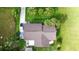 Aerial view of a home with a well-maintained roof, surrounded by lush greenery and palm trees at 109 San Rafael Ave, North Port, FL 34287