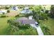Features an aerial view of a single-story home with mature landscaping and a long driveway at 109 San Rafael Ave, North Port, FL 34287