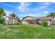 Large backyard featuring a shed, well-maintained grass, and a covered patio for outdoor enjoyment at 109 San Rafael Ave, North Port, FL 34287