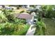 Charming home with a well-manicured lawn, palm trees, an American flag and a paved driveway at 109 San Rafael Ave, North Port, FL 34287
