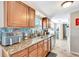 Kitchen showcasing granite countertops, wooden cabinetry, and a stylish backsplash at 109 San Rafael Ave, North Port, FL 34287