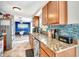 Kitchen showcasing wooden cabinets, granite countertops, stainless appliances, and tiled backsplash at 109 San Rafael Ave, North Port, FL 34287