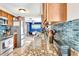 Stylish kitchen featuring granite countertops, stainless steel appliances, and a beautiful blue tiled backsplash at 109 San Rafael Ave, North Port, FL 34287