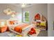 Bright bedroom with orange bedding, window, and built-in shelving at 133 Angol St, Punta Gorda, FL 33983