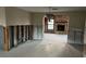 Dining room with damaged walls and flooring, showing a fireplace beyond at 13807 Plumosa Ave, Hudson, FL 34667