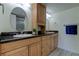 Bathroom features double sinks, wooden cabinetry, granite countertops, and large mirrors at 1430 Gulf Blvd # 204, Clearwater Beach, FL 33767