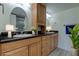 Bathroom features double sinks, wooden cabinetry, granite countertops, and large mirrors at 1430 Gulf Blvd # 204, Clearwater Beach, FL 33767