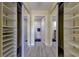 Walk-in closet with mirrored doors and built-in shelving for organized storage at 1430 Gulf Blvd # 204, Clearwater Beach, FL 33767