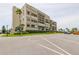 Beautiful multi-story condo building with manicured landscaping and ample parking at 1430 Gulf Blvd # 204, Clearwater Beach, FL 33767