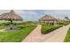 Beautiful brick paved pathway with tiki huts and well maintained landscaping on the property at 1430 Gulf Blvd # 204, Clearwater Beach, FL 33767