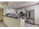 Bright kitchen with stainless steel appliances, granite counters and modern white cabinets at 1430 Gulf Blvd # 204, Clearwater Beach, FL 33767