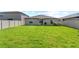 Large backyard with grassy area and privacy fence at 15410 Miller Creek Dr, Ruskin, FL 33573