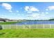 Lake view backyard with a white fence and gate at 15410 Miller Creek Dr, Ruskin, FL 33573