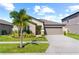 Single-story home with attached garage and landscaping at 15410 Miller Creek Dr, Ruskin, FL 33573