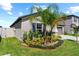 Landscaped side yard with lush greenery and palm trees at 15410 Miller Creek Dr, Ruskin, FL 33573