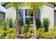 Window with blue shutters and landscaping at 15410 Miller Creek Dr, Ruskin, FL 33573