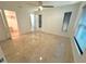 Bright bedroom with ceiling fan, two windows and tiled floors leading to walk-in closet at 1906 Castle Bay Ct, Oldsmar, FL 34677