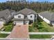 Two-story house with a large backyard and solar panels at 19270 Briarbrook Dr, Tampa, FL 33647