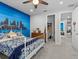 Bedroom with city skyline accent wall and access to other rooms at 19270 Briarbrook Dr, Tampa, FL 33647