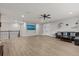 Upstairs bonus room with wood-look flooring, neutral walls, and comfortable seating area at 19270 Briarbrook Dr, Tampa, FL 33647