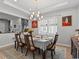 Formal dining room with a beautiful chandelier and seating for six at 19270 Briarbrook Dr, Tampa, FL 33647