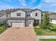 Two-story house with gray siding, three-car garage, and a basketball hoop at 19270 Briarbrook Dr, Tampa, FL 33647