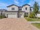 Two-story house with a three-car garage, basketball hoop, and landscaped yard at 19270 Briarbrook Dr, Tampa, FL 33647