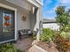 Front porch with a bench, fall decorations, and landscaping at 19270 Briarbrook Dr, Tampa, FL 33647