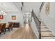 Inviting hallway featuring a wooden staircase with iron railings, leading to a formal dining room at 19270 Briarbrook Dr, Tampa, FL 33647