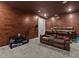 Elegant home theater room with brown leather seating and wood-paneled walls at 19270 Briarbrook Dr, Tampa, FL 33647