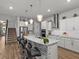 Modern kitchen featuring a large island with seating and stone backsplash at 19270 Briarbrook Dr, Tampa, FL 33647