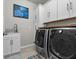 Spacious laundry room with washer, dryer, and extra cabinets at 19270 Briarbrook Dr, Tampa, FL 33647
