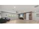 Large living room featuring wood-look flooring, a comfortable sofa, and a wood paneled accent wall at 19270 Briarbrook Dr, Tampa, FL 33647