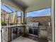 Luxury outdoor kitchen with grill, refrigerator, and stone accents at 19270 Briarbrook Dr, Tampa, FL 33647