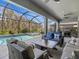 Relaxing patio with a covered lanai, pool, and outdoor kitchen at 19270 Briarbrook Dr, Tampa, FL 33647