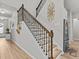 Elegant staircase with wooden steps, black iron railing, and decorative wall accents leading to the upper level at 19270 Briarbrook Dr, Tampa, FL 33647