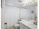Bright bathroom with tub shower, vanity with double sinks at 2231 Utopian E Dr # 321, Clearwater, FL 33763