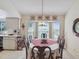 Bright dining room with bay window and round dining table at 2231 Utopian E Dr # 321, Clearwater, FL 33763