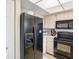 Well-equipped kitchen featuring black appliances and ample counter space at 2231 Utopian E Dr # 321, Clearwater, FL 33763