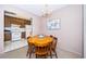 Charming dining area with round table and kitchen view at 2700 Bayshore Blvd # 4304, Dunedin, FL 34698