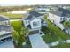 An aerial view of a two-story home showcasing its lawn, nearby community pond, and an attached two-car garage at 33975 Astoria Cir, Wesley Chapel, FL 33545