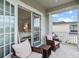 Balcony with woven furniture set adjacent to bedroom with sliding glass doors offering views at 33975 Astoria Cir, Wesley Chapel, FL 33545